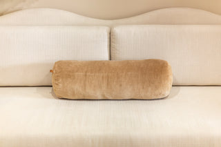 Saardé Truffle velvet bolster cushion on a cream sofa
